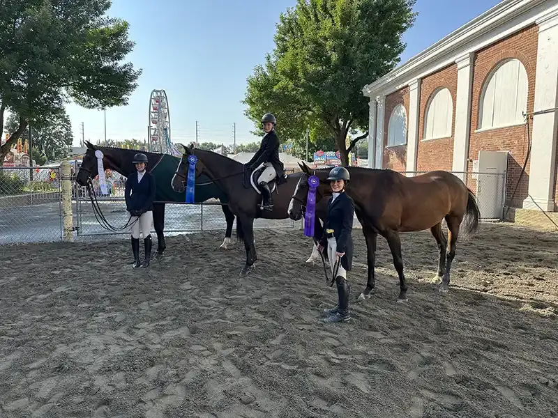 Three riders with ribbons
